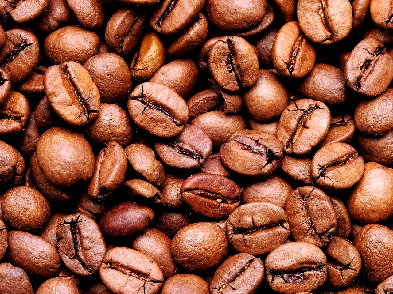 High-quality close-up image of aromatic roasted coffee beans, perfect for food and beverage themes.